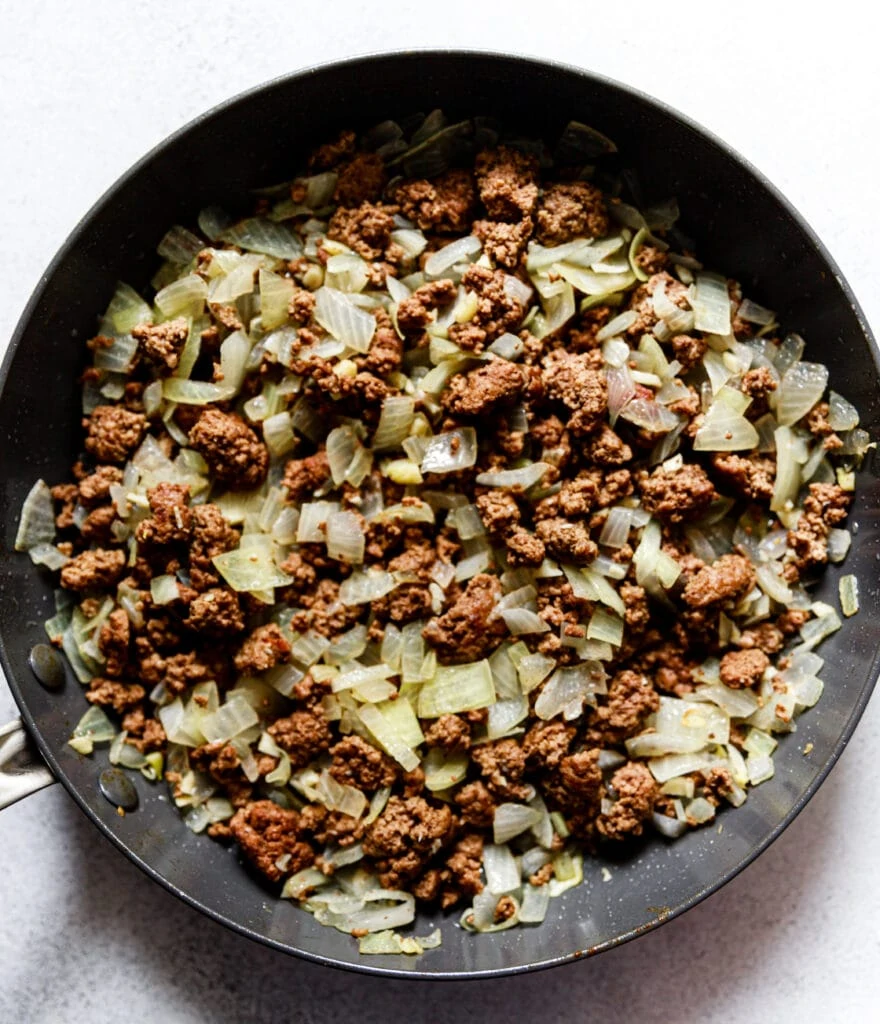 ground beef, garlic, and onions in a skillet