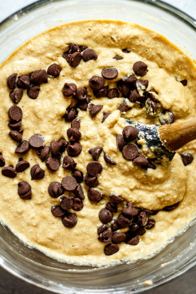 chocolate chips being stirred in batter