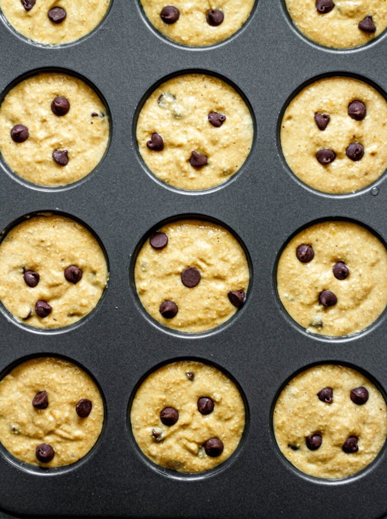 banana chocolate chip muffin batter in muffin tin