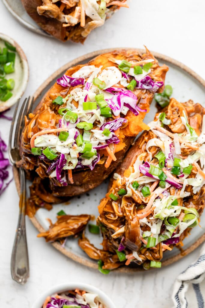 bbq chicken stuffed sweet potatoes on plate with fork