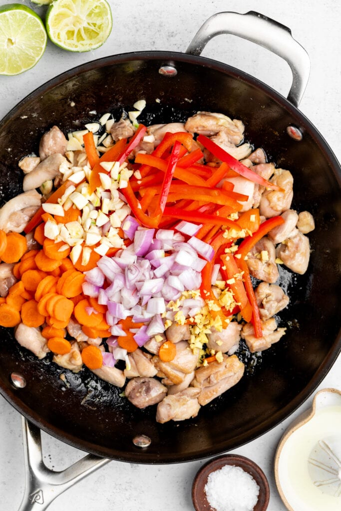 chicken and veggies in black pan