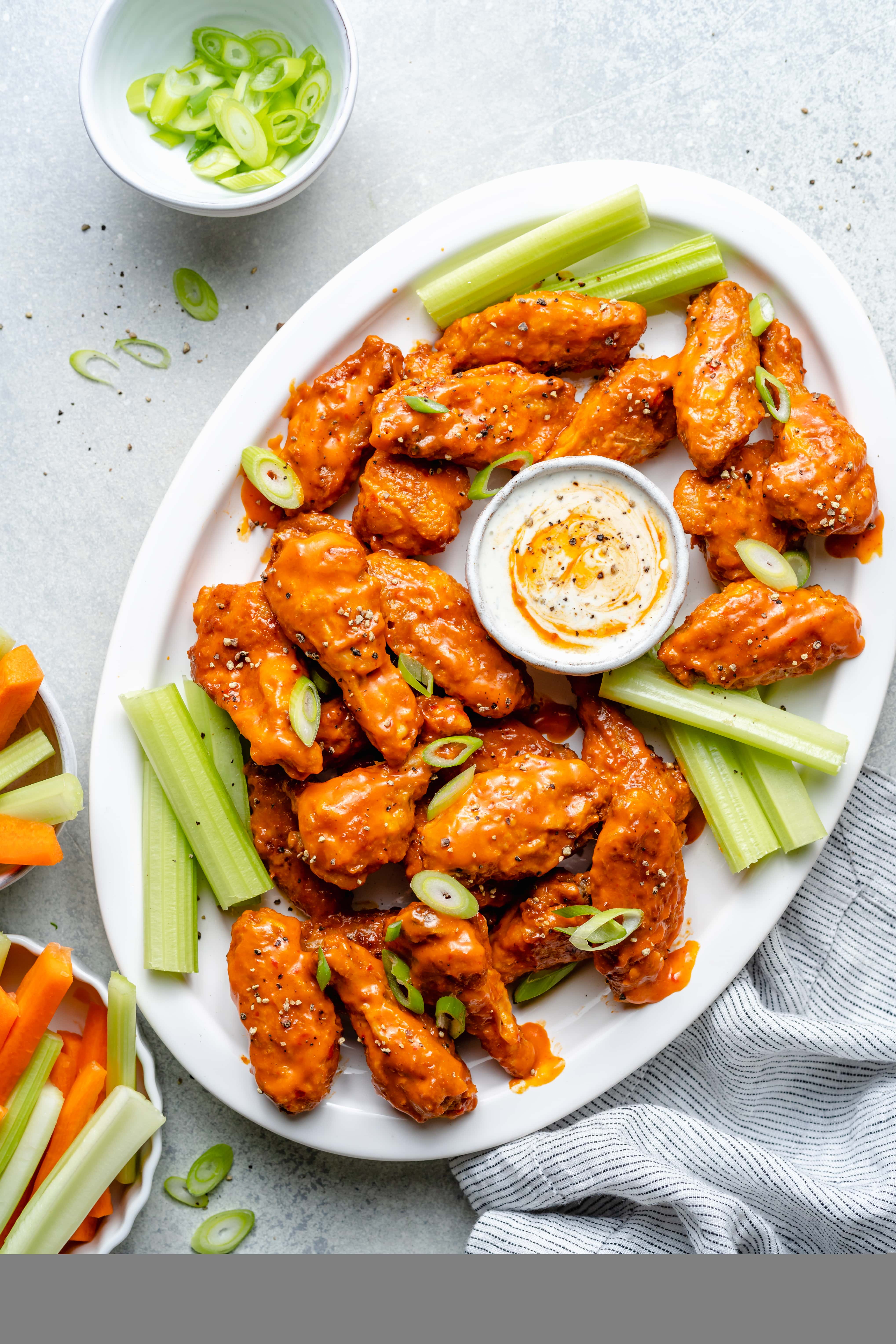 crispy baked buffalo chicken wings on platter with dip