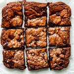 gluten free triple chocolate cookie dough bars on white parchment paper