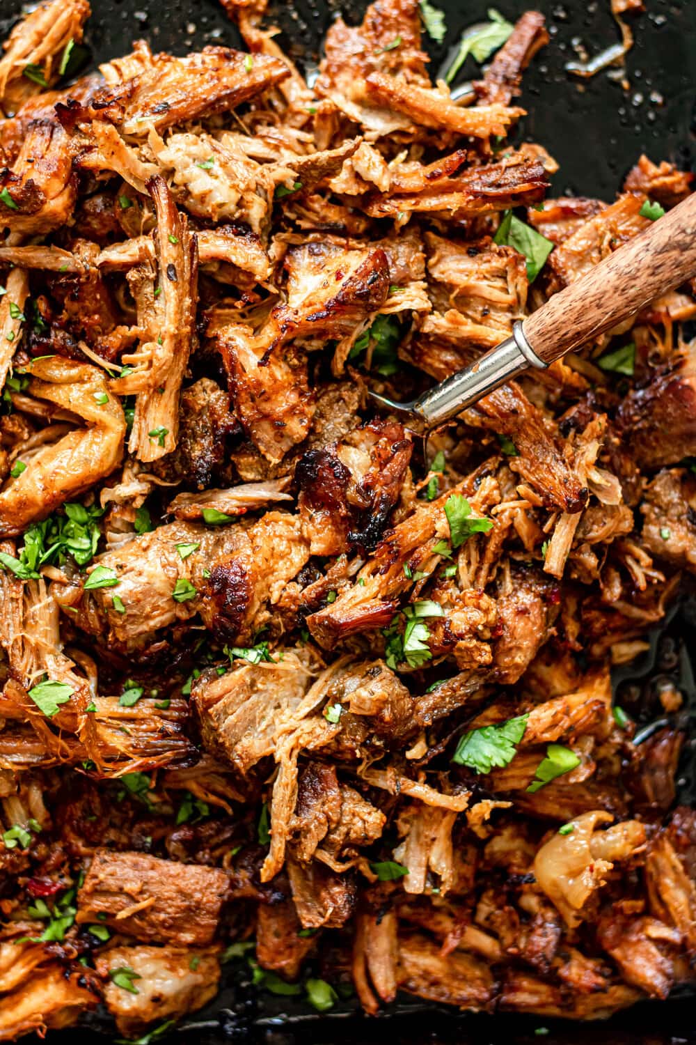 crispy pork carnitas on a sheet pan with fork