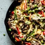 Philly cheesesteak skillet topped with green onions