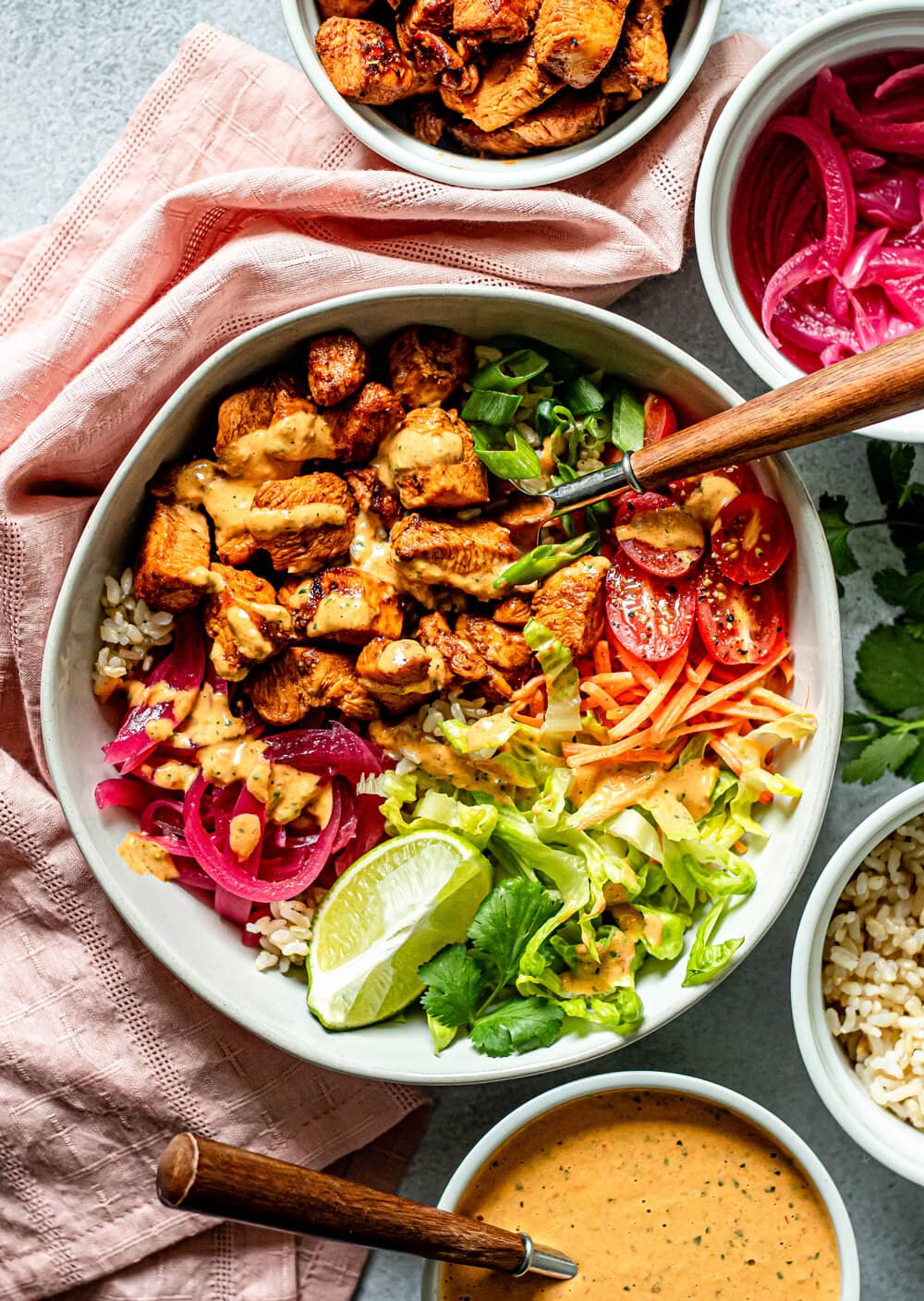 Honey Chipotle Chicken Bowls with Spicy Lime Tahini Dressing in a white bowl with veggies and chicken 