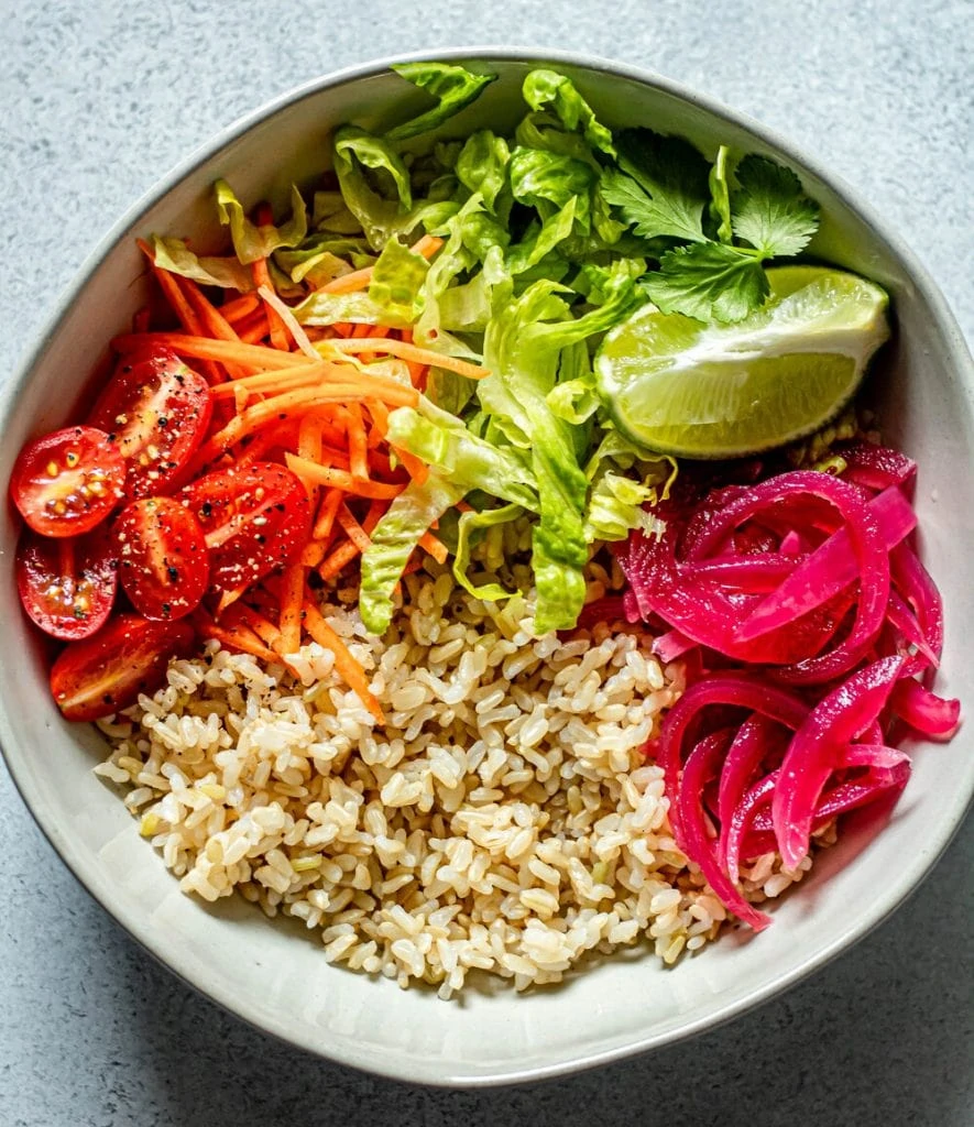 veggies and brown rice in white bowl
