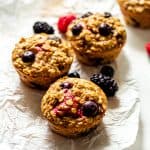 triple berry baked oatmeal cups on white parchment