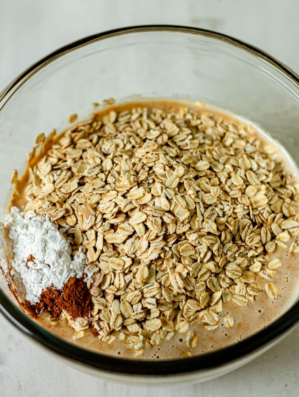 oats, cinnamon, baking powder in a glass mixing bowl