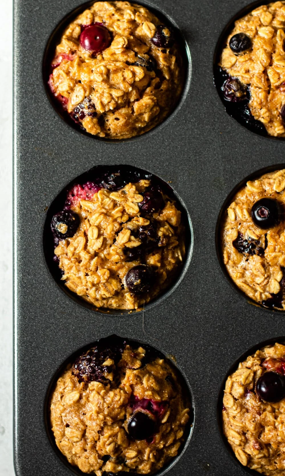 Triple Berry Baked Oatmeal Cups in a muffin pan