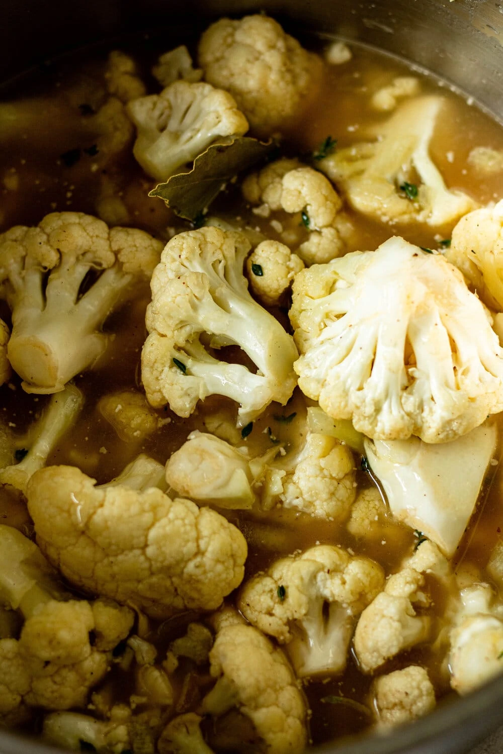 cauliflower florets, broth, and a bay leaf in large stock pot