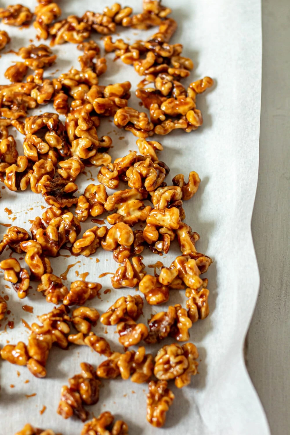 Honey Glazed Walnuts on a sheet pan lined with parchment paper