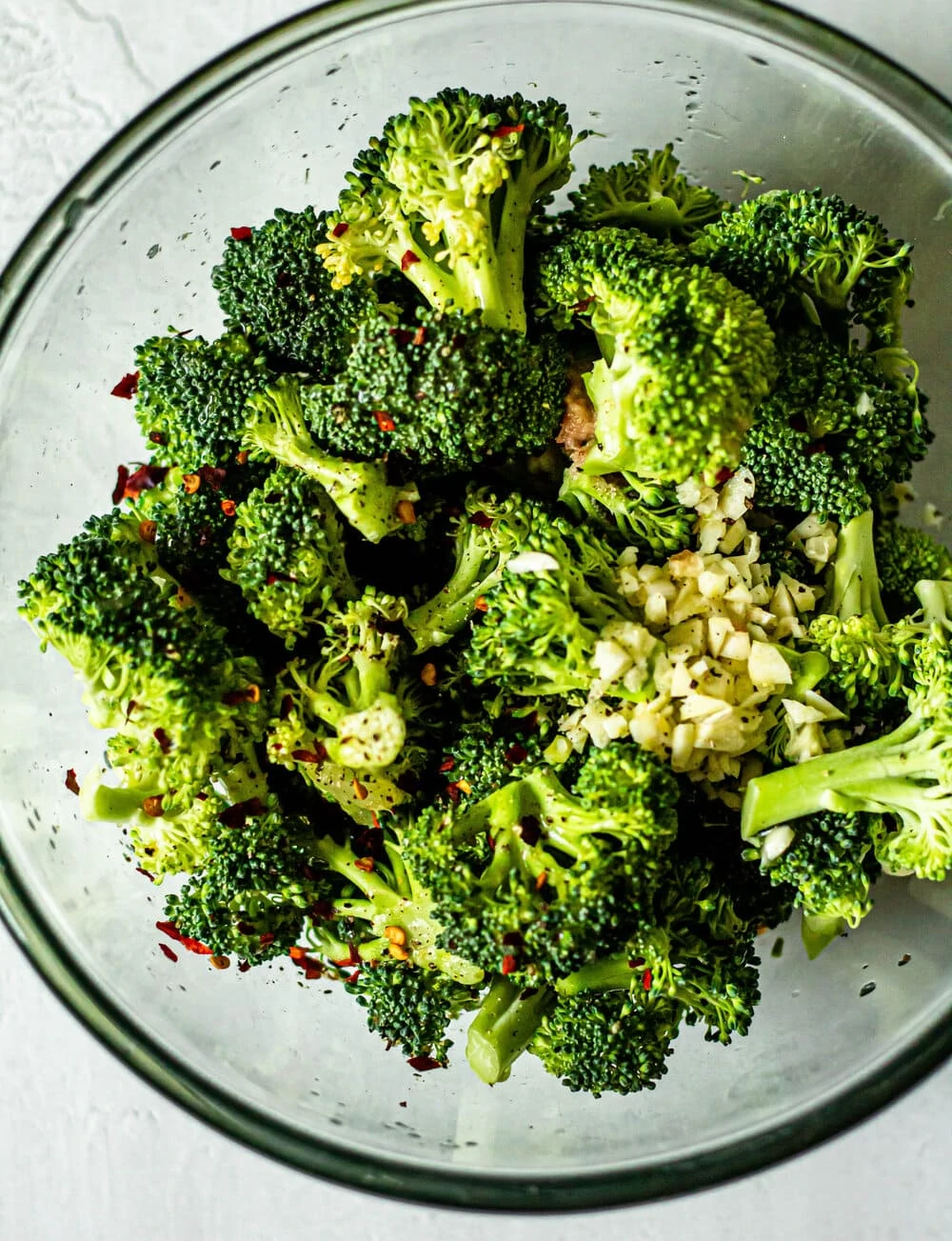 fresh broccoli in a glass mixing bowl