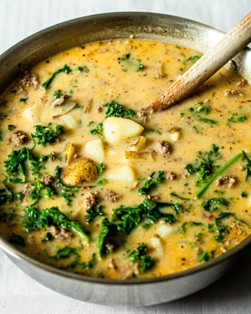 soup in pot with wooden spoon