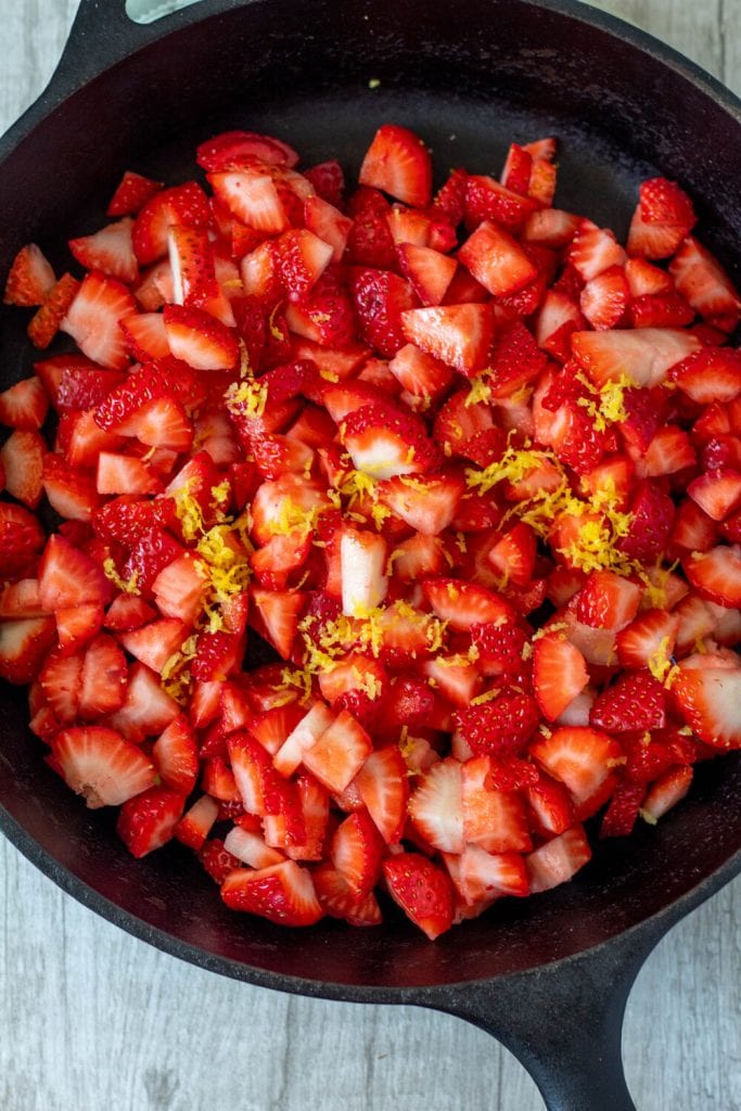 strawberries and lemon zest in skillet