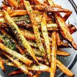 Air Fryer French fries in a clear mixing bowl seasoned with ranch seasoning