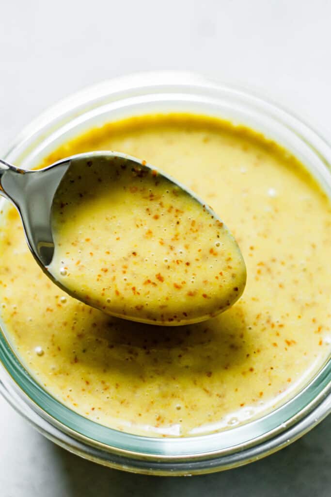 honey mustard dressing on a silver spoon