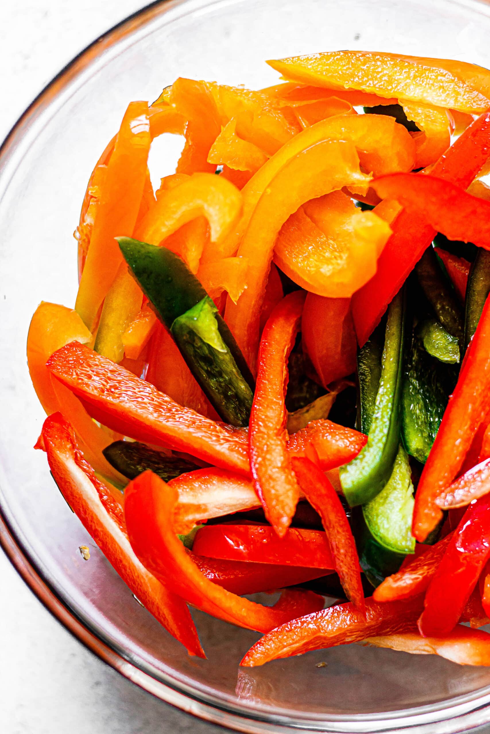 sliced peppers in glass mixing bowl