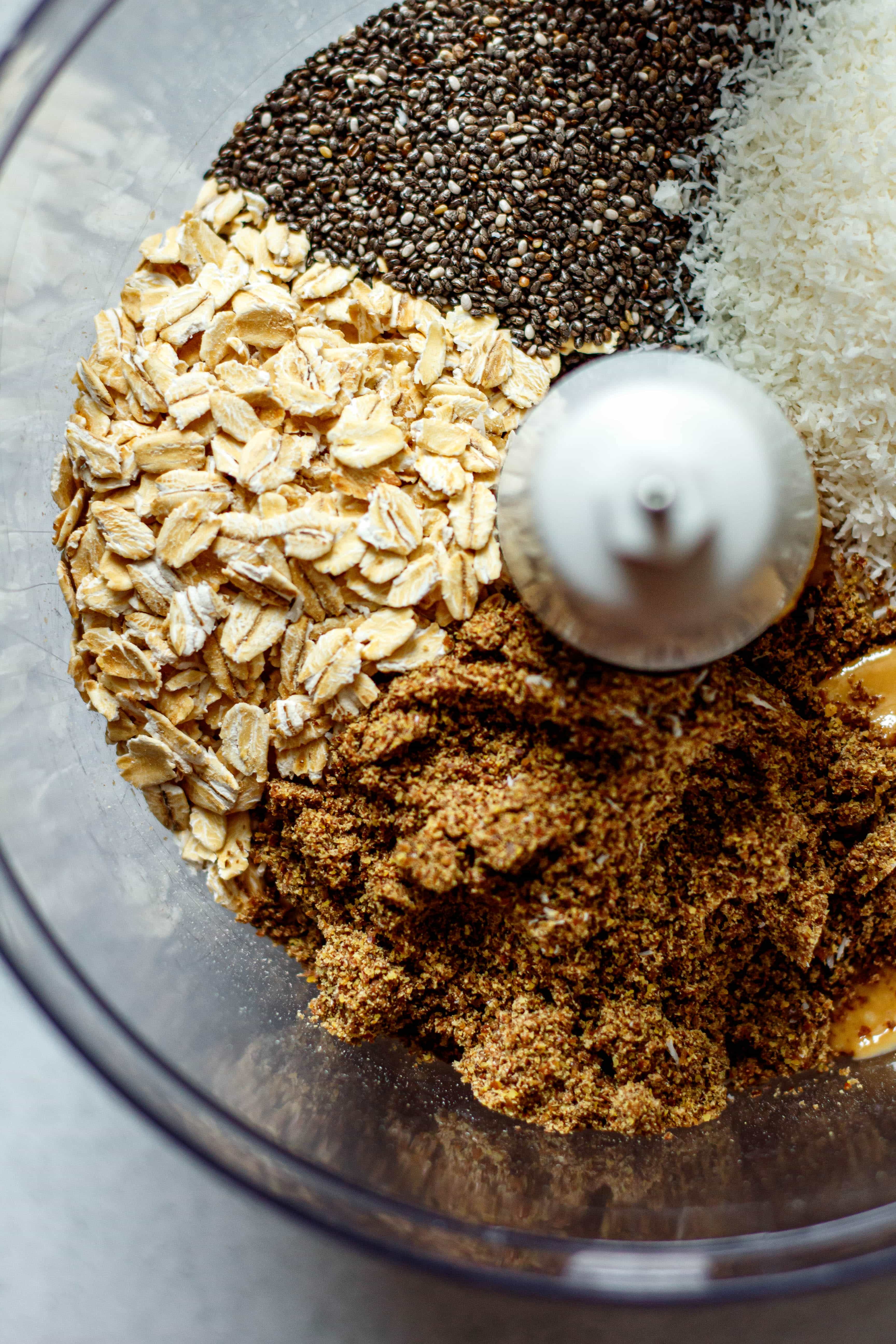 oats, chia seeds, flax seeds, and coconut in a food processor