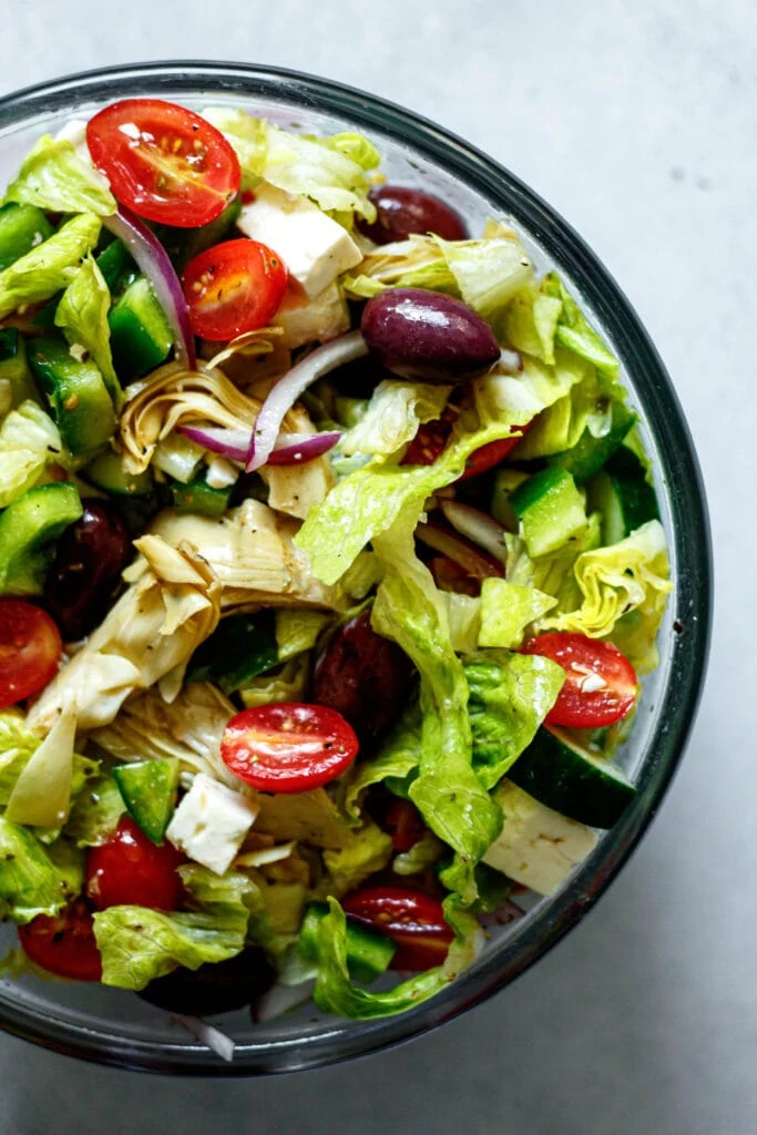 greek salad in large clear mixing bowl