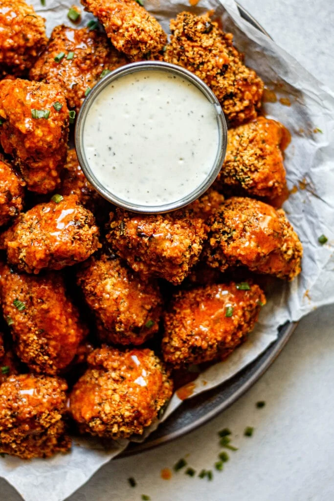 Crispy Buffalo Ranch Chicken Nuggets on a plate with ranch dressing
