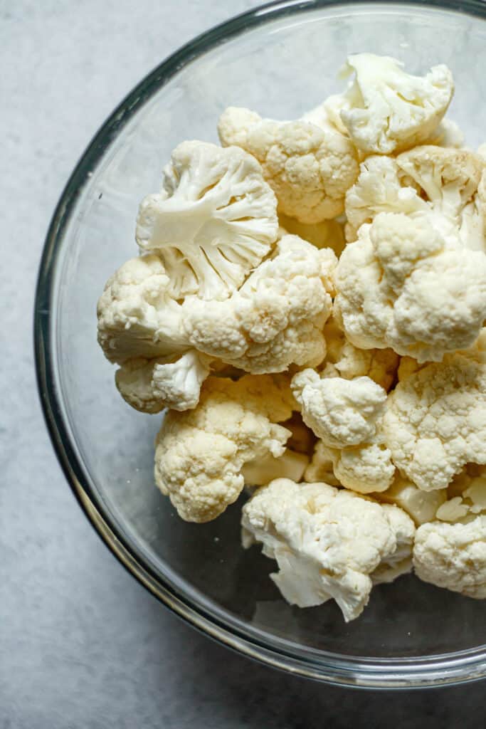 cauliflower florets in a clear mixing bowl
