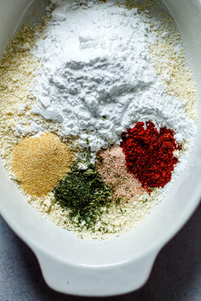 almond flour, tapioca starch, and spices in a shallow dish