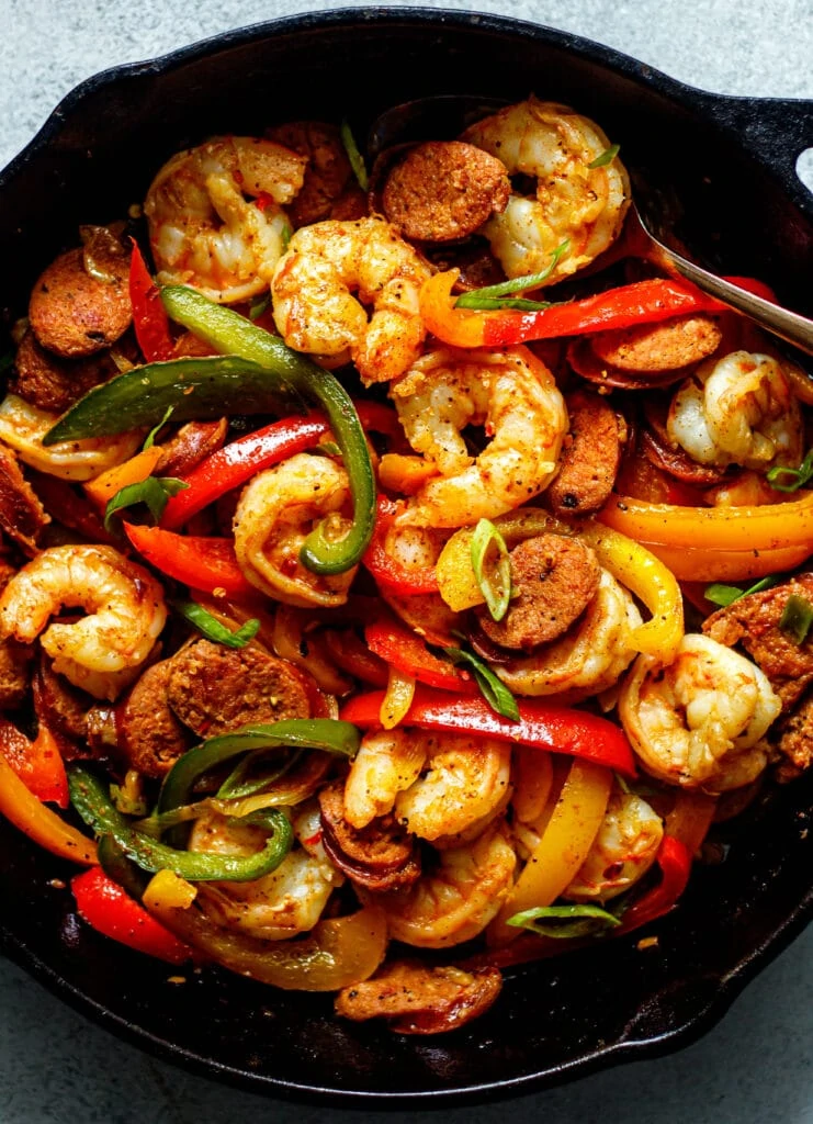 sausage, shrimp, peppers, onion in a cast iron skillet