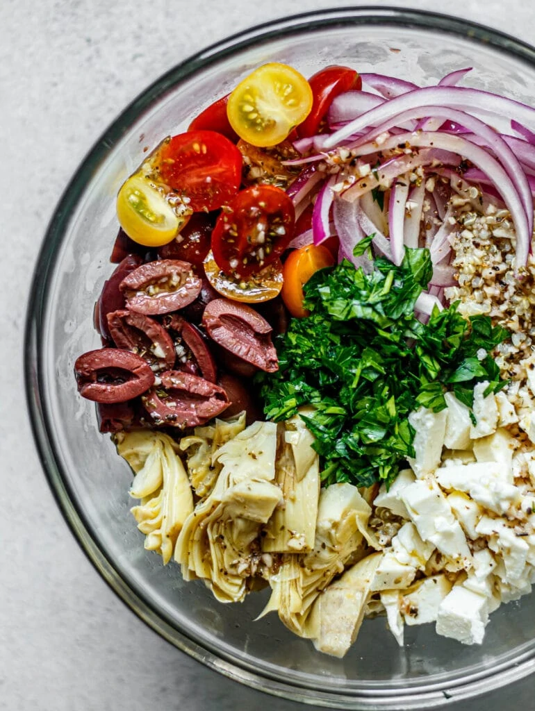 salad ingredients in large glass mixing bowl