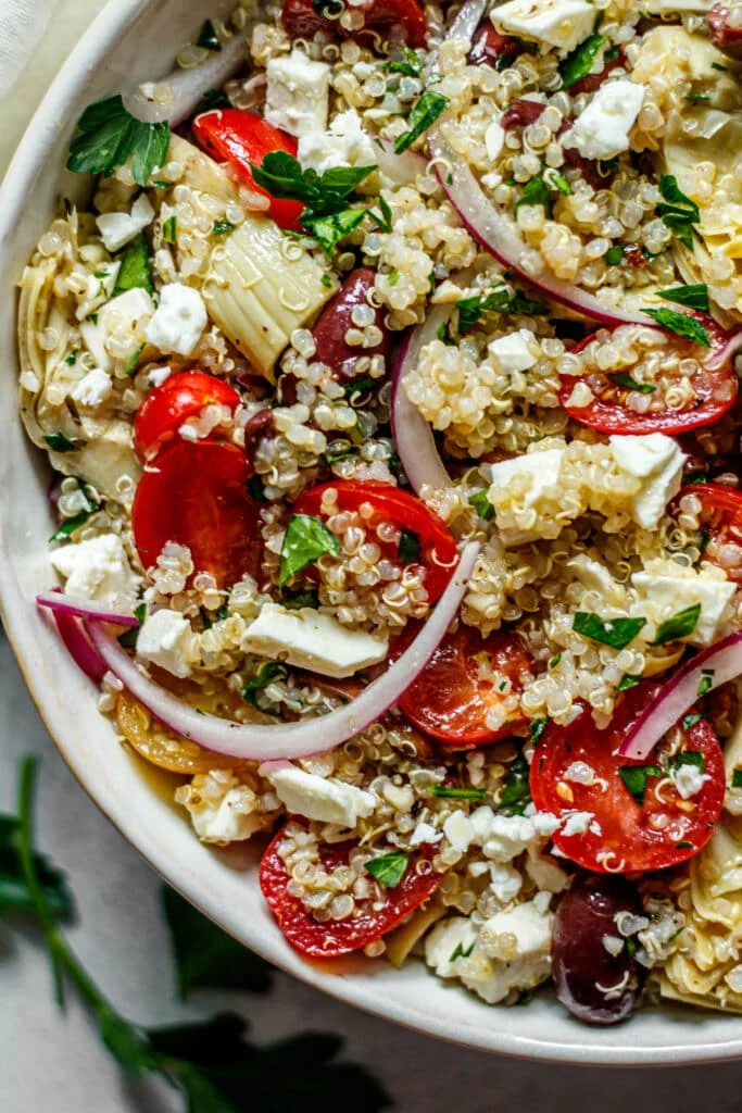 Mediterranean quinoa salad in a white serving bowl