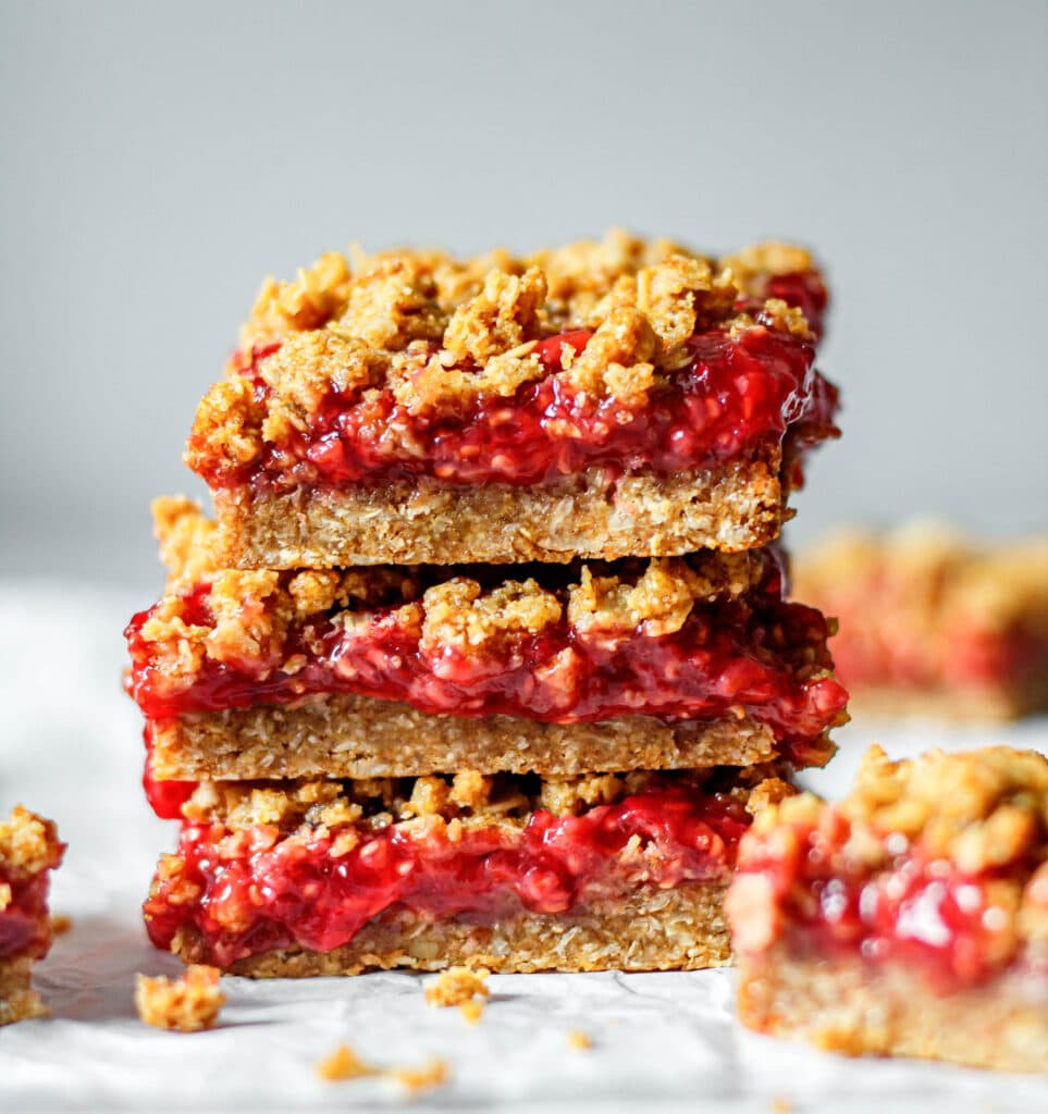 healthy raspberry oatmeal bars stacked on each other
