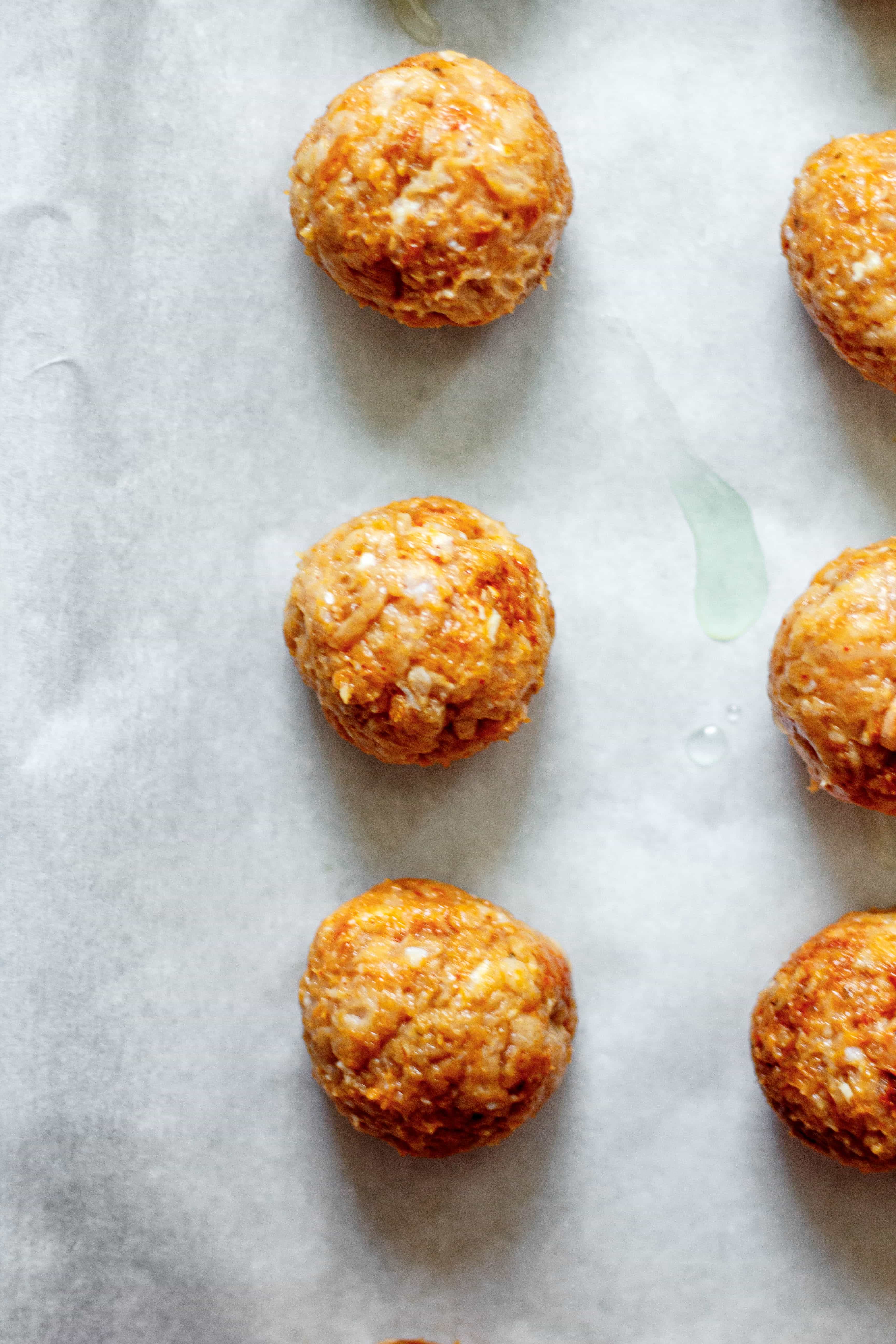 chicken meatballs on parchment paper