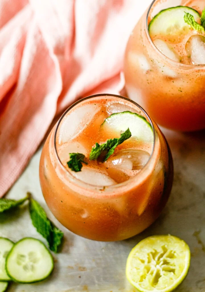 cucumber watermelon mojito in glass with cucumber and mint on the side