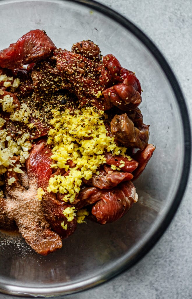 sliced steak with garlic, ginger, salt, and pepper