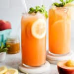 peach lemonades in glasses with straw