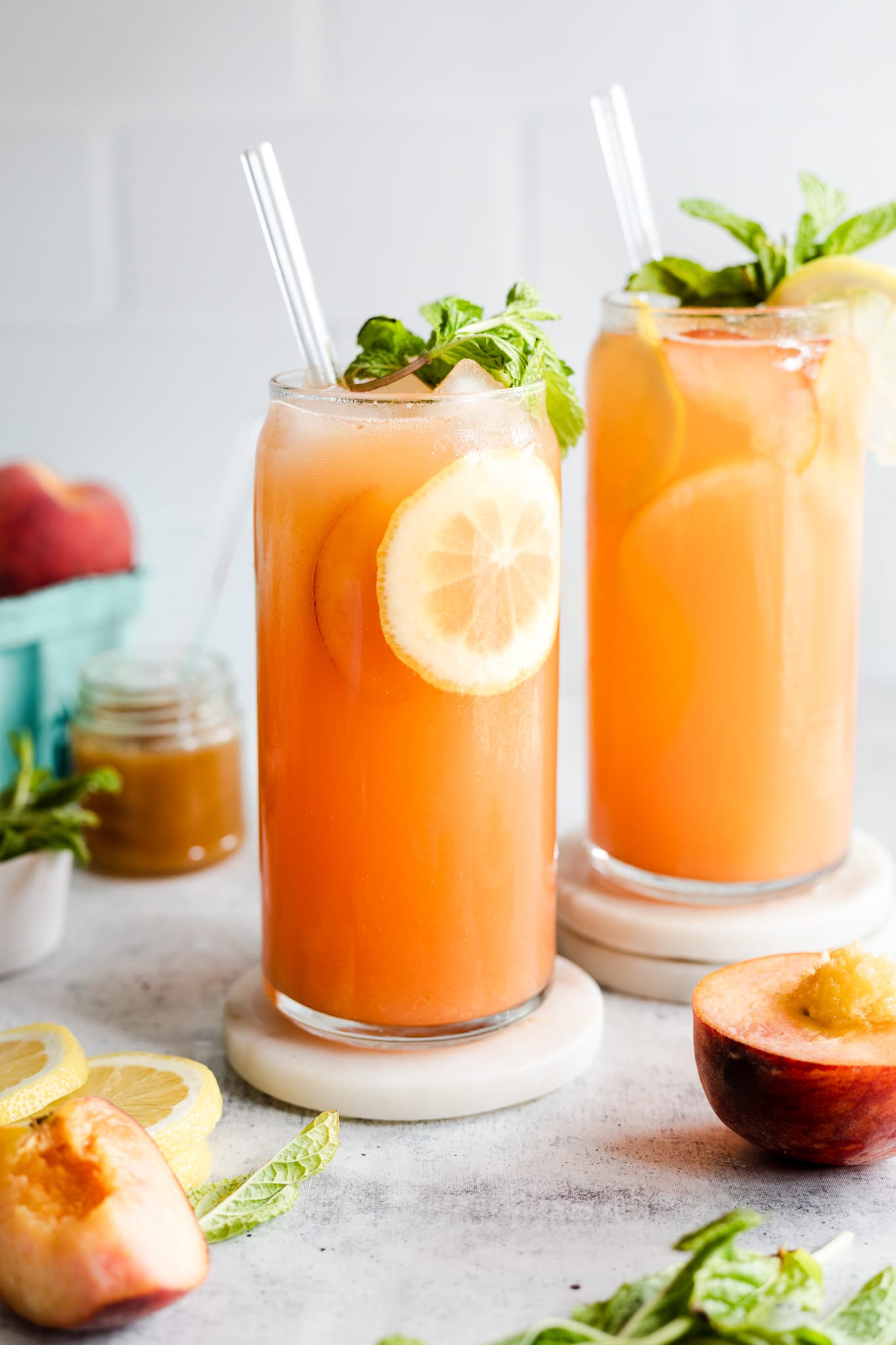 peach lemonades in glasses with straw