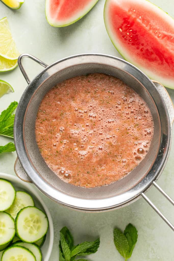 watermelon mixture being strained