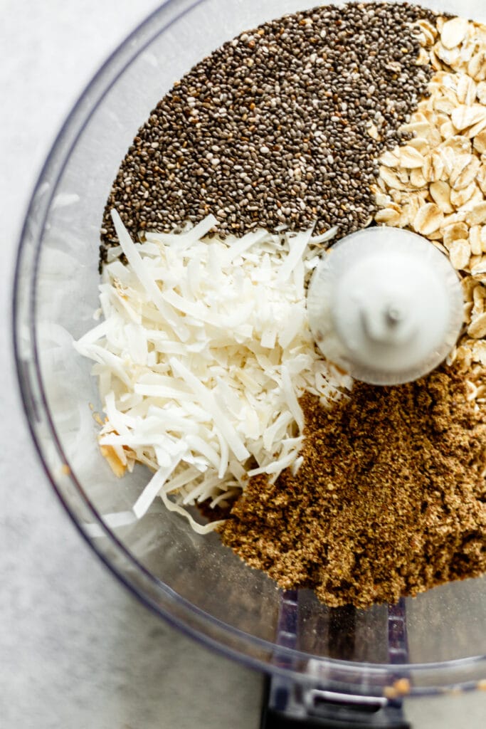 flax seed, chia seeds, coconut, and gluten free oats in food processor bowl
