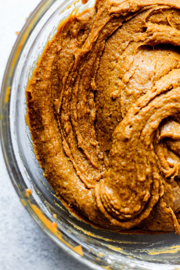 pumpkin bread batter in glass mixing bowl