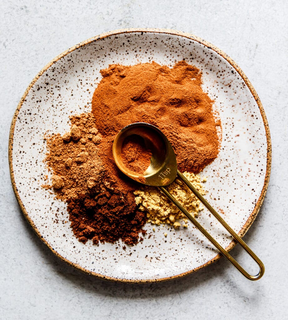 spices on a small plate with measuring spoon