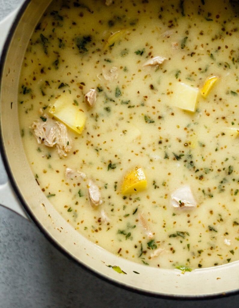 chicken, potatoes, broth, and herbs in dutch oven