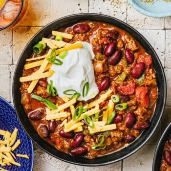 pumpkin chili in bowl with toppings