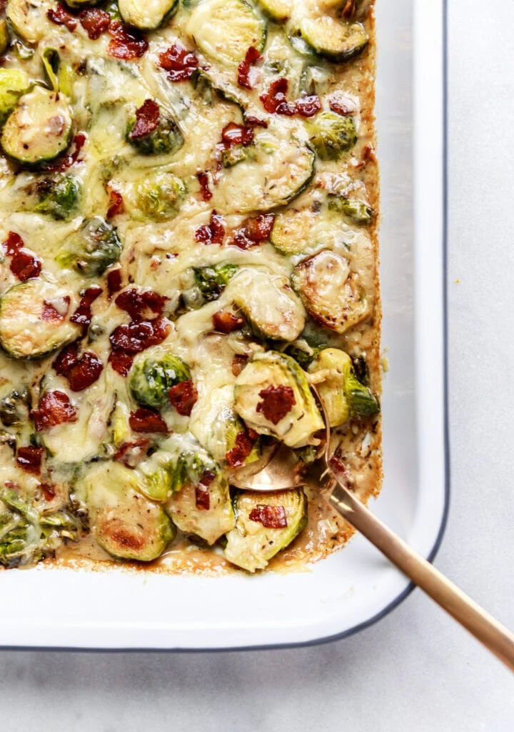 Brussels sprouts au gratin in pan with spoon