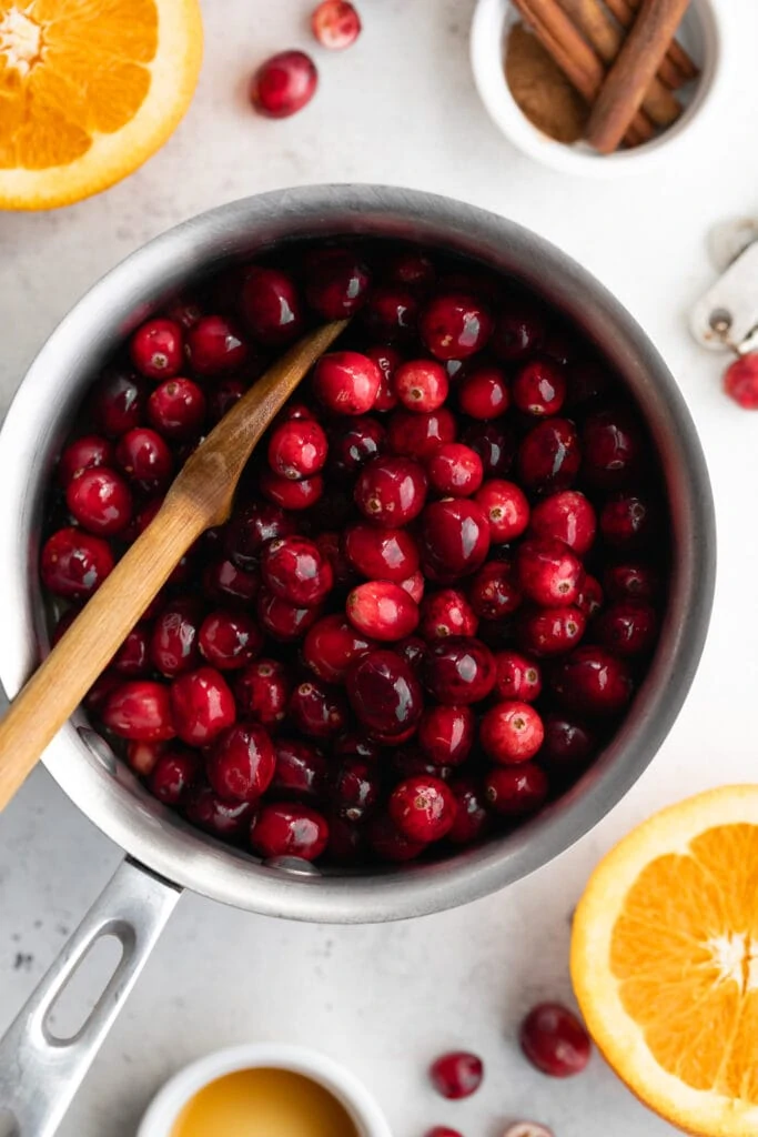 cranberries in pot with wooden spoon