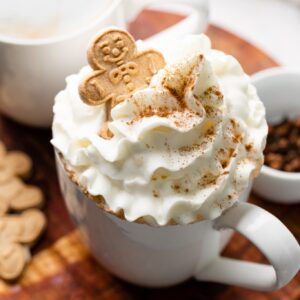latte with whipped cream and cookie