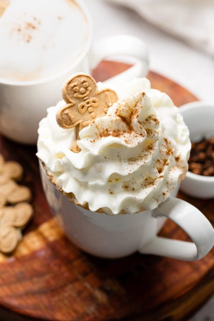 latte with whipped cream and cookie