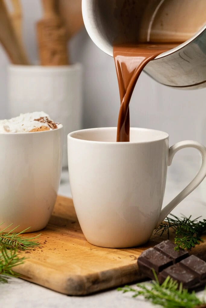 hot chocolate being poured into mug