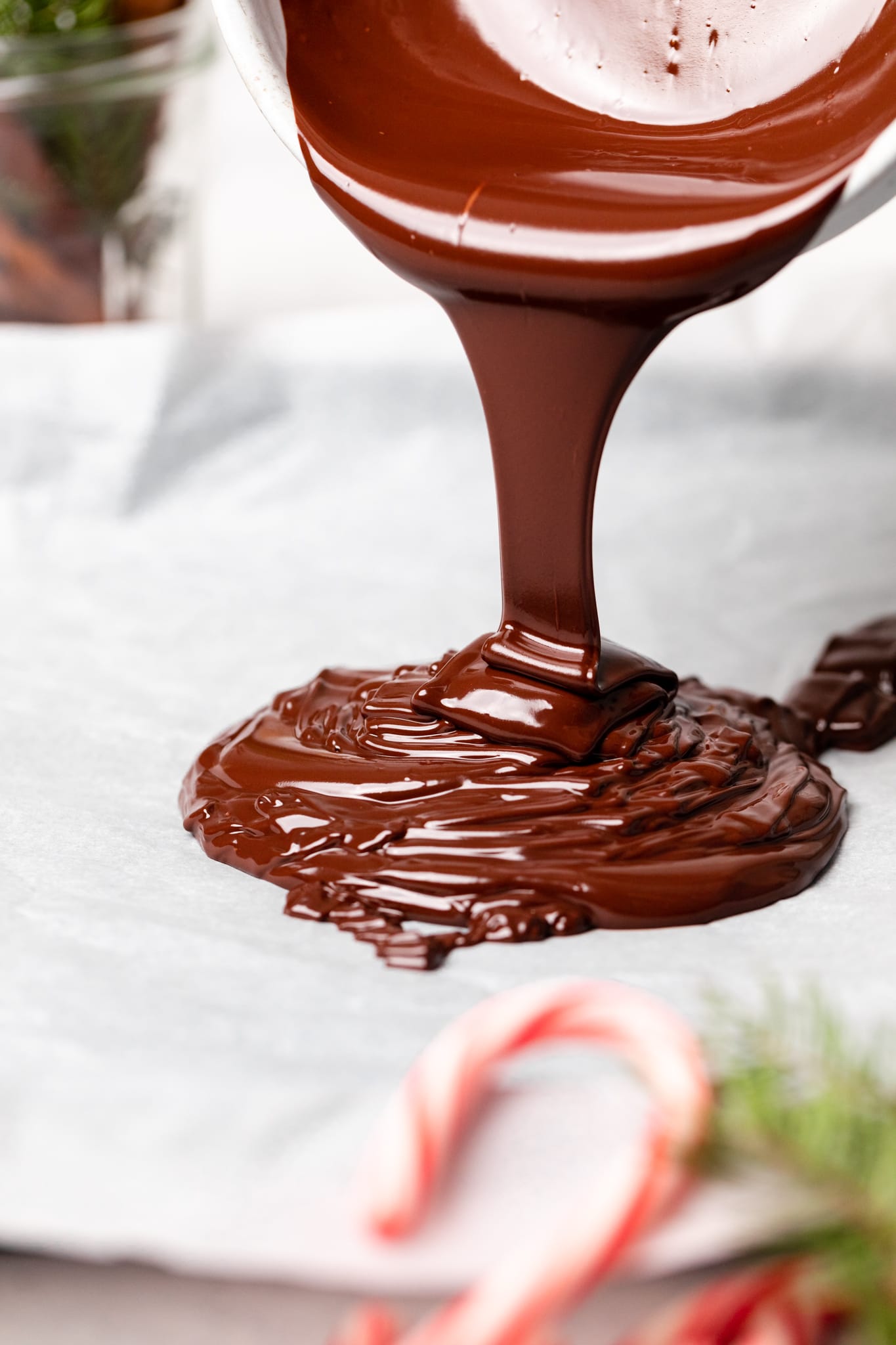 melted chocolate being poured on parchment
