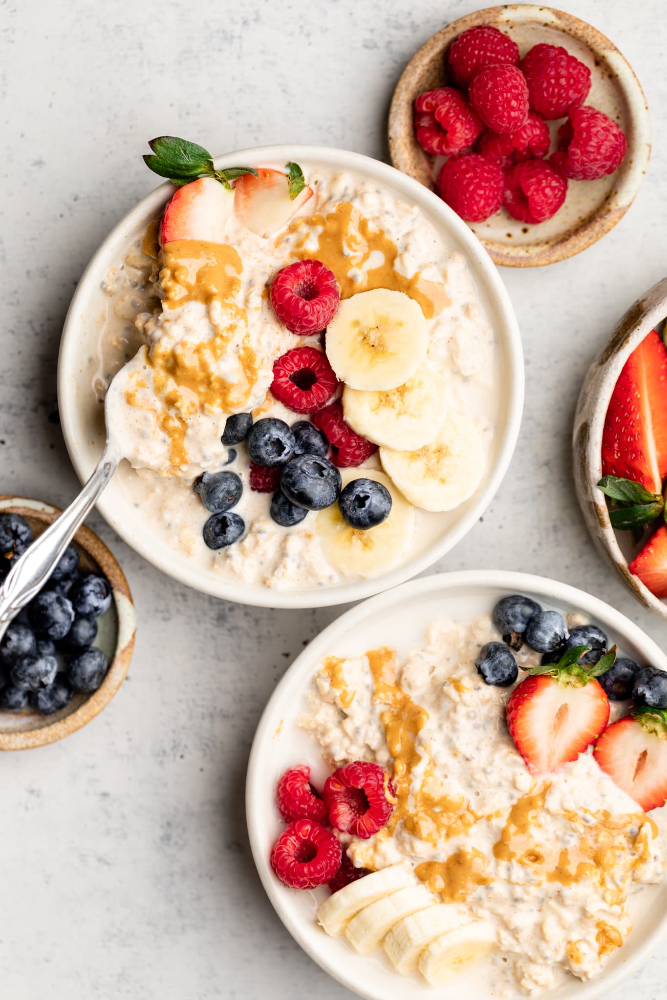 peanut butter overnight oats in bowls topped with fruit