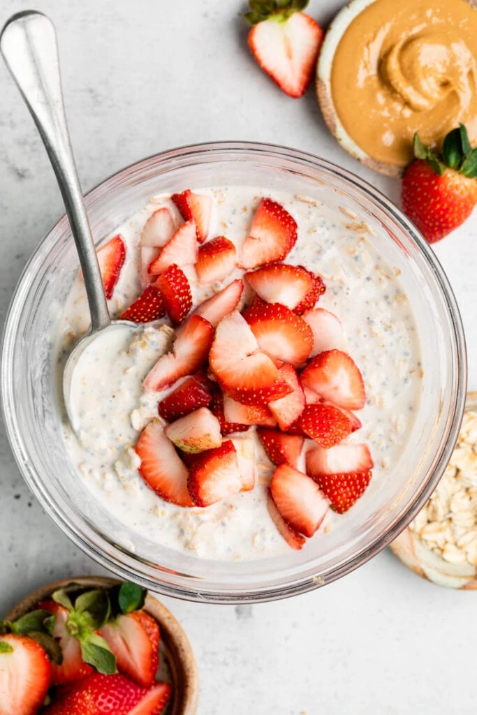 oats and strawberries in a bowl with a spoon